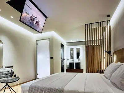a bedroom with a large bed with a tv on the ceiling at Comfort and Relaxation in Athens