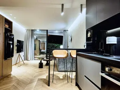 a kitchen with a counter and some chairs in it at Comfort and Relaxation in Athens