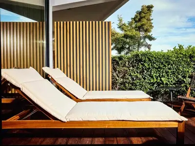 two beds sitting on a porch with a fence at Comfort and Relaxation in Athens