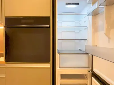 an empty refrigerator with its door open in a kitchen at Elegant Living in Glyfada Center in Athens