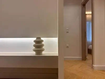 a room with a table with a sculpture on it at Elegant Living in Glyfada Center in Athens