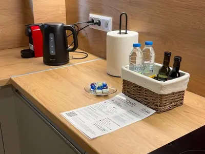 a counter with a basket of bottles of wine on it at Elegant Living in Glyfada Center in Athens