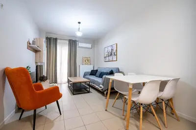 a living room with a table and chairs and a couch at Downtown Family Apartment - Walk to Metro by ΜΡS in Athens