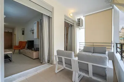 a living room with a couch and a table at Downtown Family Apartment - Walk to Metro by ΜΡS in Athens