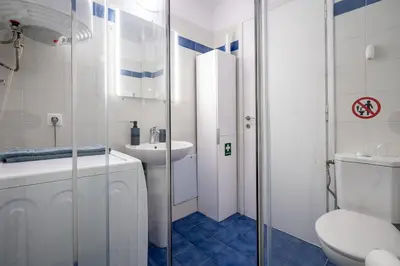 a white bathroom with a sink and a toilet at Downtown Family Apartment - Walk to Metro by ΜΡS in Athens