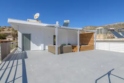 a house with a large roof with a patio at NEW Dodekanisou 53 Glifada in Athens