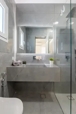 a bathroom with a sink and a toilet and a mirror at NEW Dodekanisou 53 Glifada in Athens