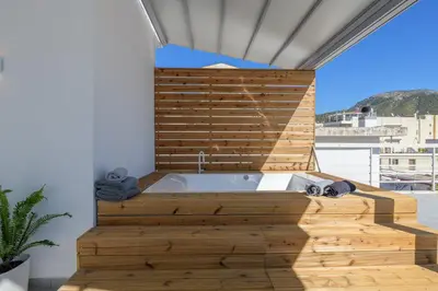 a bath tub in a room with a wooden wall at NEW Dodekanisou 53 Glifada in Athens