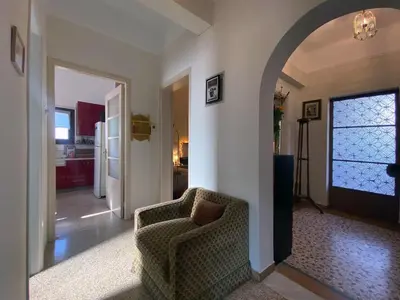 a living room with a chair and a hallway at Bamboo & Bird House, Chalandri in Athens