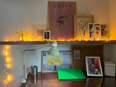 a desk with a green laptop on a shelf with lights at Bamboo & Bird House, Chalandri in Athens