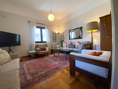 a living room with a couch and a tv at Bamboo & Bird House, Chalandri in Athens