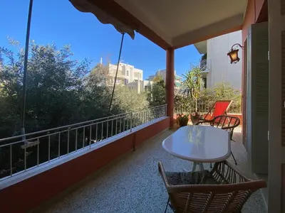 a balcony with a white table and chairs on it at Bamboo & Bird House, Chalandri in Athens