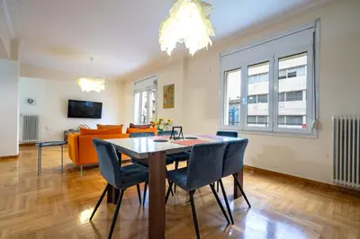 a living room with a table and chairs and a couch at Blue Harmony 3BR - Heart of Athens by ΜΡS in Athens