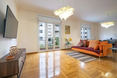 a living room with a couch and a flat screen tv at Blue Harmony 3BR - Heart of Athens by ΜΡS in Athens