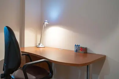 a wooden desk with a lamp and a chair at Blue Harmony 3BR - Heart of Athens by ΜΡS in Athens