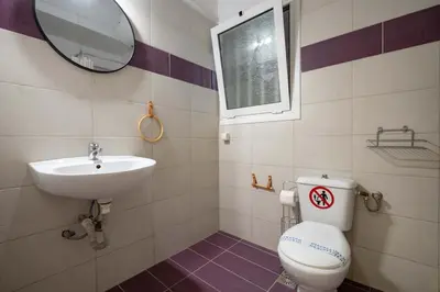 a bathroom with a toilet and a sink and a mirror at Blue Harmony 3BR - Heart of Athens by ΜΡS in Athens