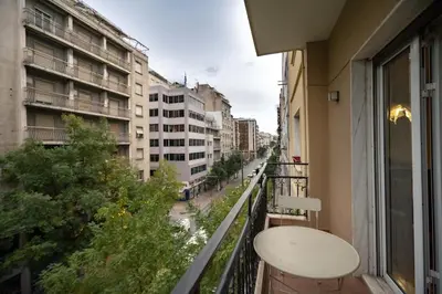 a balcony with a table and a view of a city at Blue Harmony 3BR - Heart of Athens by ΜΡS in Athens