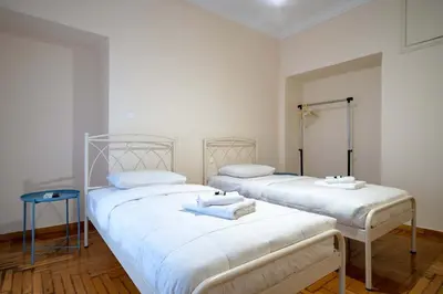 two beds in a room with white walls at Blue Harmony 3BR - Heart of Athens by ΜΡS in Athens
