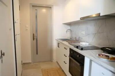 a kitchen with a sink and a counter top at Best House Kalipso Neo Faliro Piraeus in Piraeus