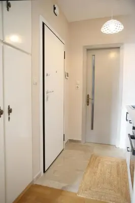 a hallway with a sliding door and a hallway with a rug at Best House Kalipso Neo Faliro Piraeus in Piraeus