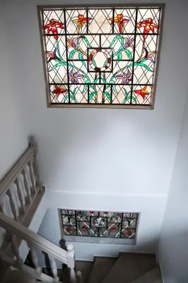 a stained glass window on the ceiling of a staircase at Best House Kalipso Neo Faliro Piraeus in Piraeus