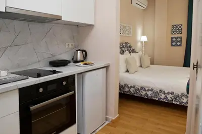 a small kitchen with a bed in a room at Best House Kalipso Neo Faliro Piraeus in Piraeus