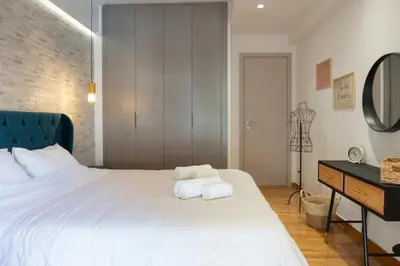 a bedroom with a white bed with towels on it at Valtinon Smart Corner in Athens