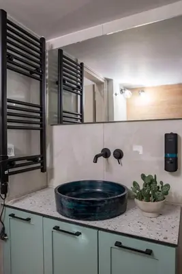 a bathroom sink with a blue glass bowl on a counter at Valtinon Smart Corner in Athens