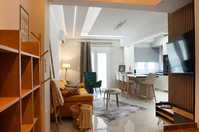a living room with a couch and a table at Valtinon Smart Corner in Athens