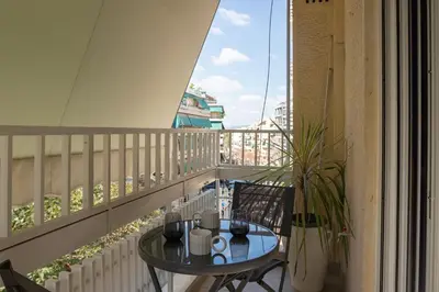 a balcony with a table and chairs on a balcony at Valtinon Smart Corner in Athens