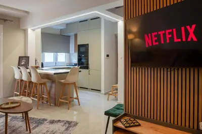 a living room with a netflix sign on a wall at Valtinon Smart Corner in Athens