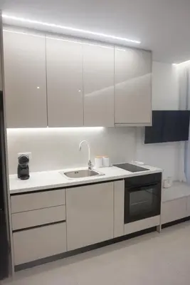 a kitchen with white cabinets and a sink at City Heart Luxury Boutique Suites in Athens