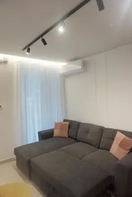 a living room with a couch and a window at City Heart Luxury Boutique Suites in Athens