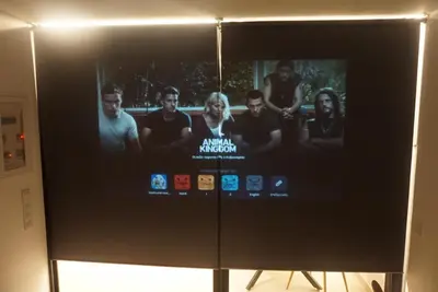 a television screen with a group of people on it at City Heart Luxury Boutique Suites in Athens