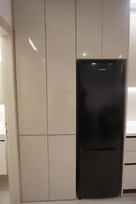 a black refrigerator in a kitchen with white walls at City Heart Luxury Boutique Suites in Athens