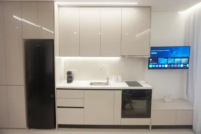 a white kitchen with a sink and a refrigerator at City Heart Luxury Boutique Suites in Athens