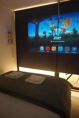 a bedroom with a flat screen tv and a bed at City Heart Luxury Boutique Suites in Athens