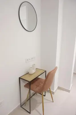 a table and a chair with a mirror on the wall at City Heart Luxury Boutique Suites in Athens