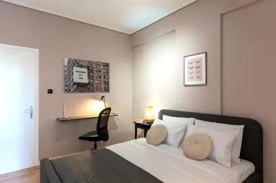 a bedroom with a bed with two pillows on it at Athenian Bliss Spotless Nea Smyrni WiFi Studio in Athens