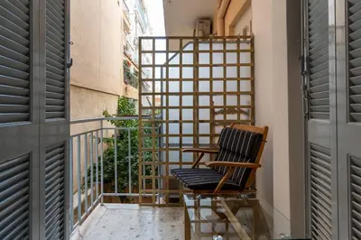 a balcony with a chair and a railing at Athenian Bliss Spotless Nea Smyrni WiFi Studio in Athens