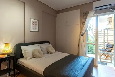 a bedroom with a bed and a sliding glass door at Athenian Bliss Spotless Nea Smyrni WiFi Studio in Athens