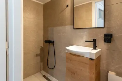 a bathroom with a sink and a mirror at Athenian Bliss Spotless Nea Smyrni WiFi Studio in Athens