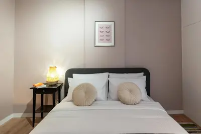 a bedroom with a bed with two pillows on it at Athenian Bliss Spotless Nea Smyrni WiFi Studio in Athens