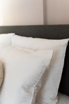 a white bed with white pillows on it at Athenian Bliss Spotless Nea Smyrni WiFi Studio in Athens