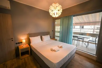a bedroom with a large bed with a chandelier at Aiolou 97 Majestic Acropolis View by Zeus Suites in Athens