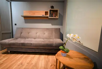a living room with a couch and a table at Aiolou 97 Majestic Acropolis View by Zeus Suites in Athens