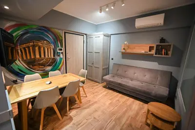 a living room with a table and a couch at Aiolou 97 Majestic Acropolis View by Zeus Suites in Athens