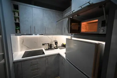 a small kitchen with a sink and a refrigerator at Aiolou 97 Majestic Acropolis View by Zeus Suites in Athens
