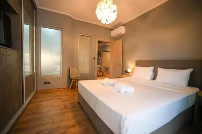 a bedroom with a bed with two towels on it at Aiolou 97 Majestic Acropolis View by Zeus Suites in Athens