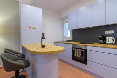 a kitchen with a counter with wine glasses on it at Acropolis walking distance apartment in Athens